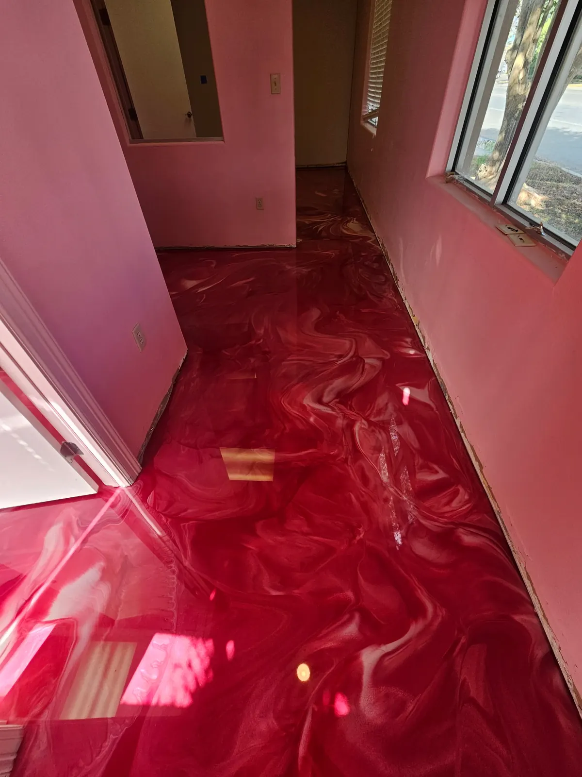 Red metallic epoxy floor in a bright interior room