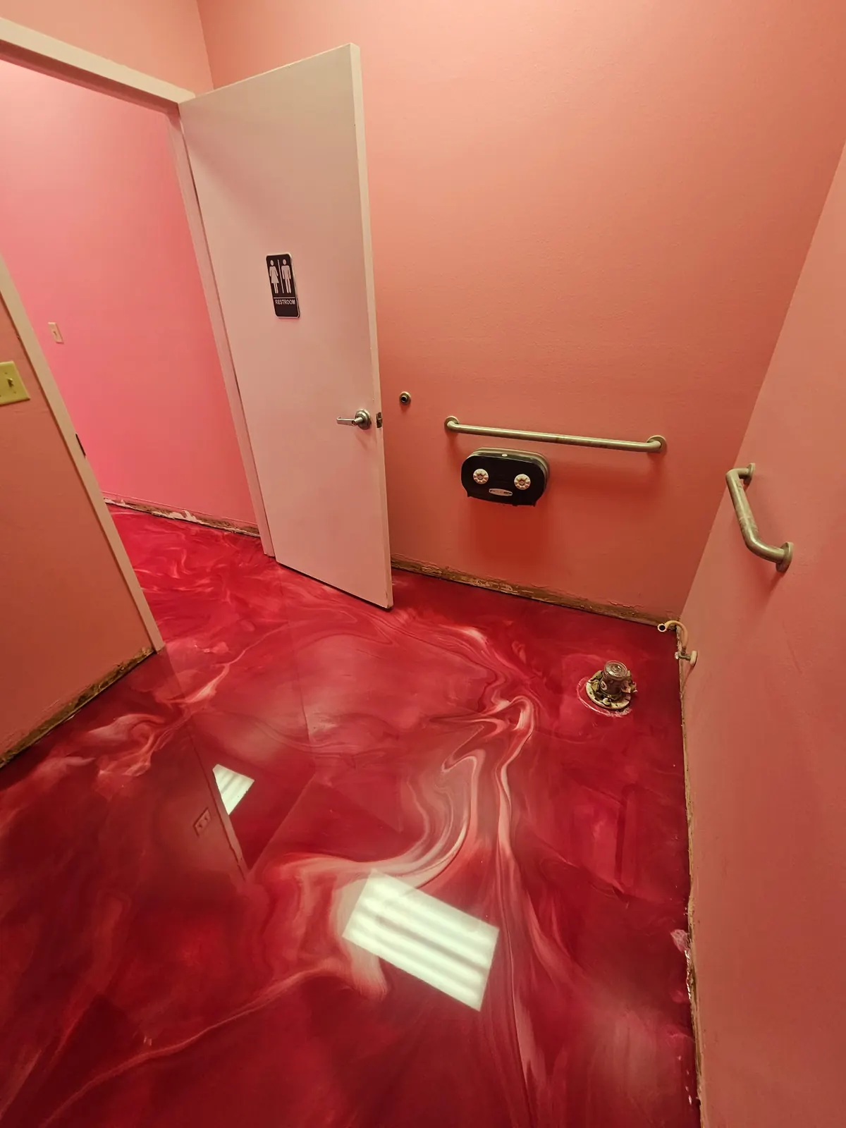 Red metallic epoxy floor in a bright interior room, view 8