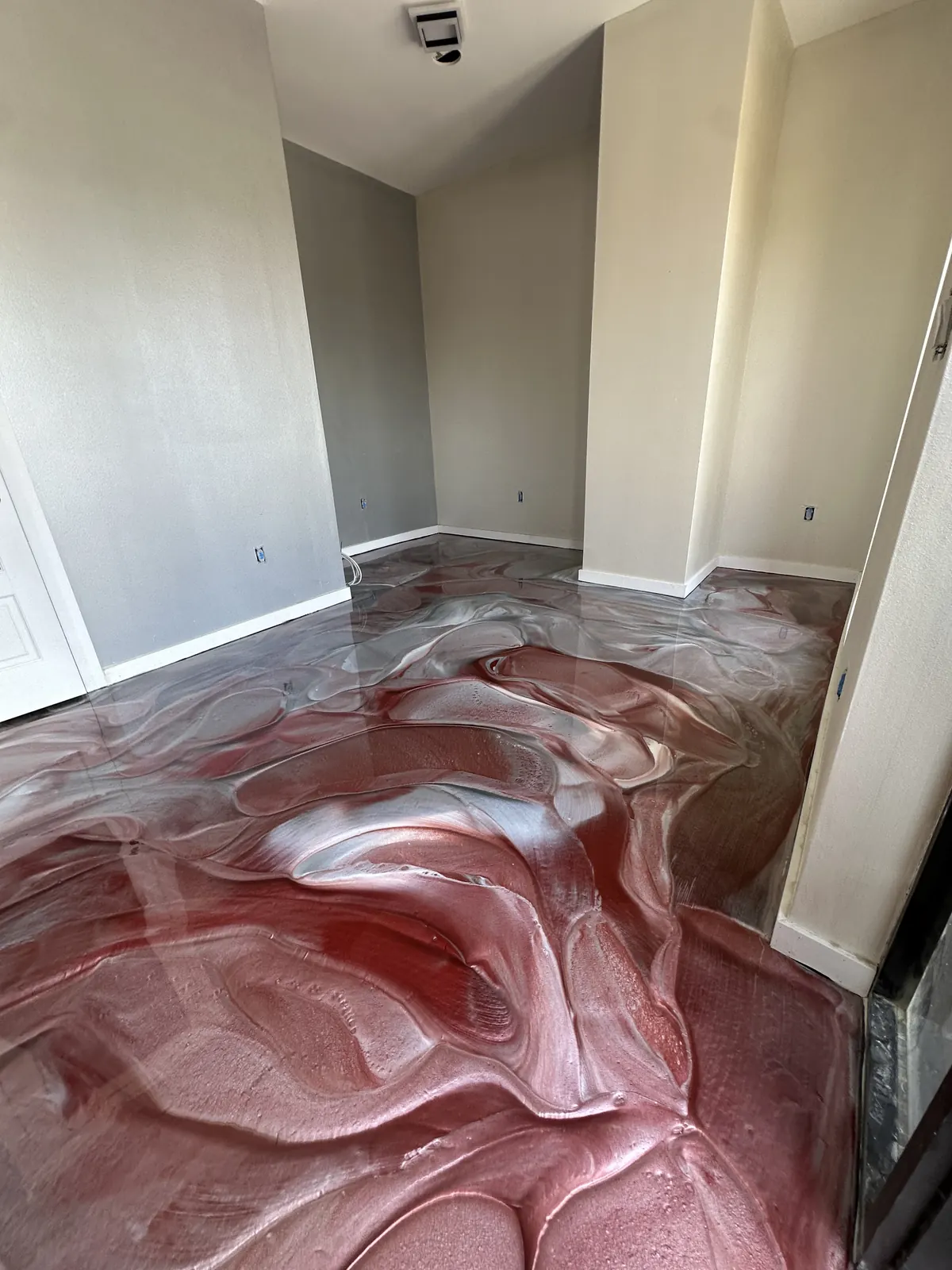 Red and silver metallic epoxy floor in an office hallway, view 4