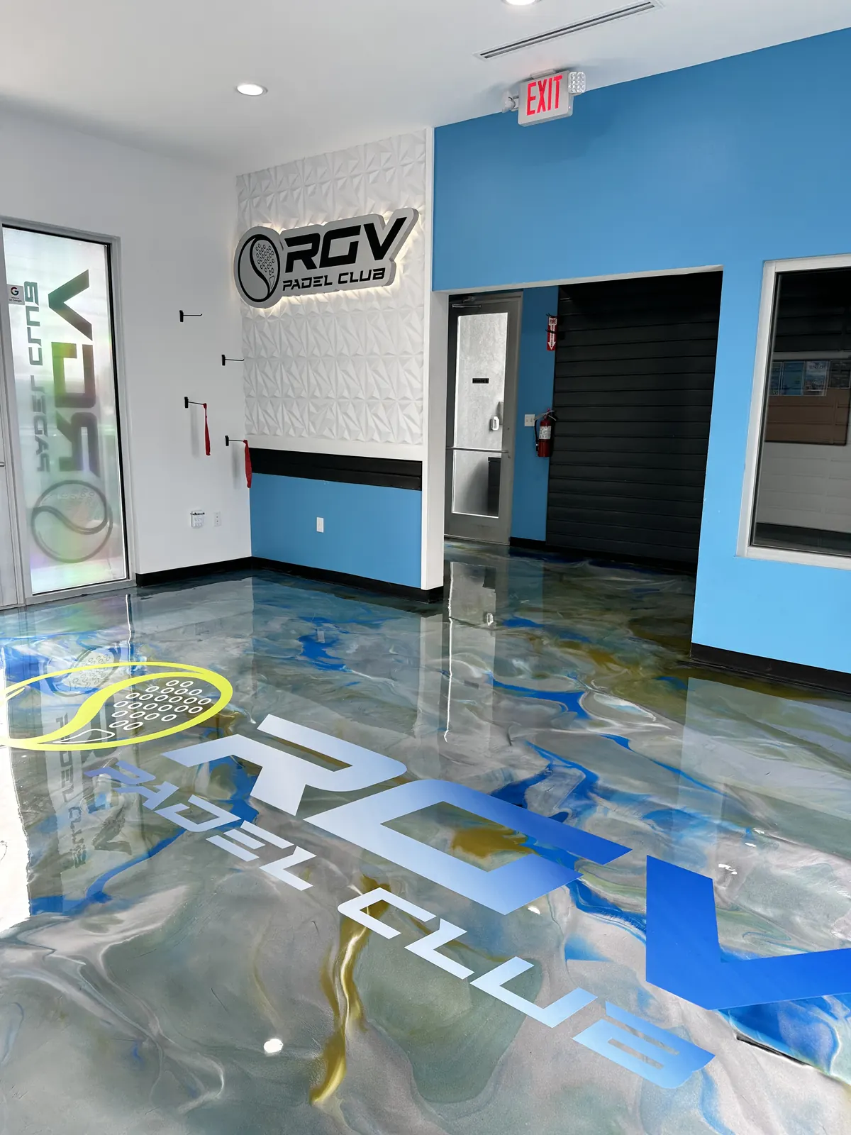 Blue and gold metallic epoxy floor with the RGV Padel Club logo, view 2