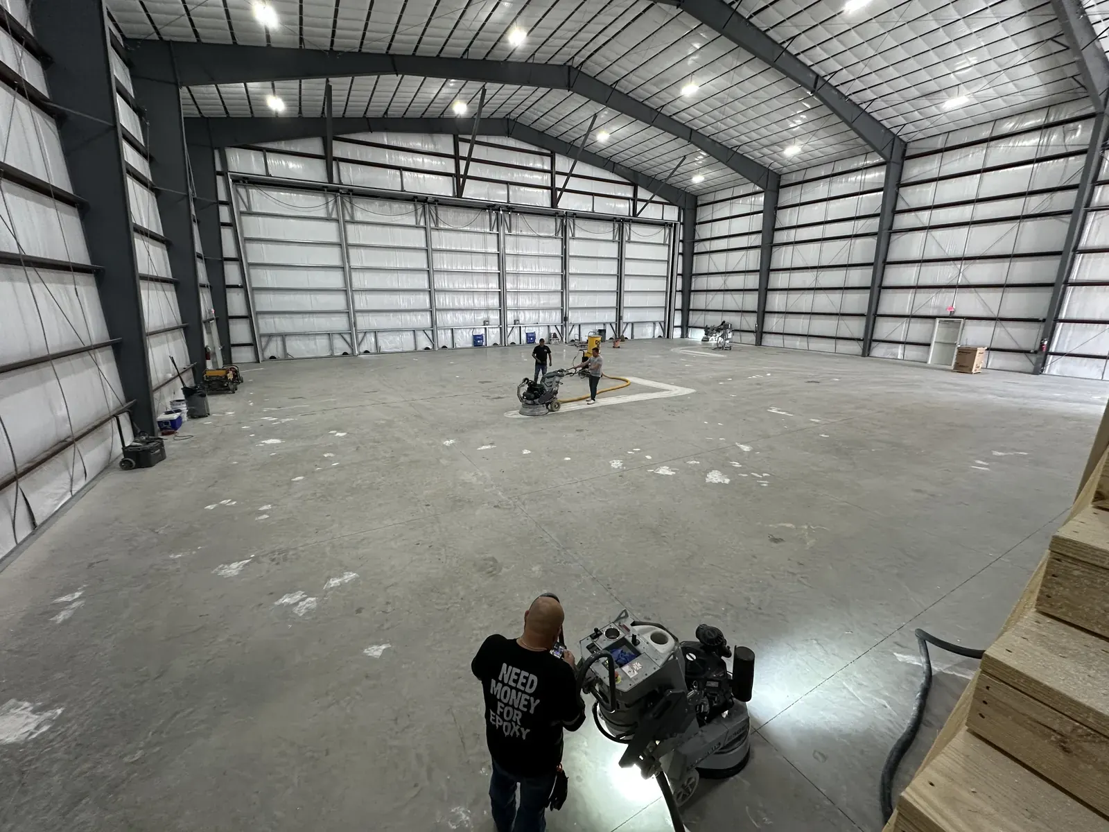 NanoTech Epoxy crew diamond grinding concrete before an epoxy installation, view 2