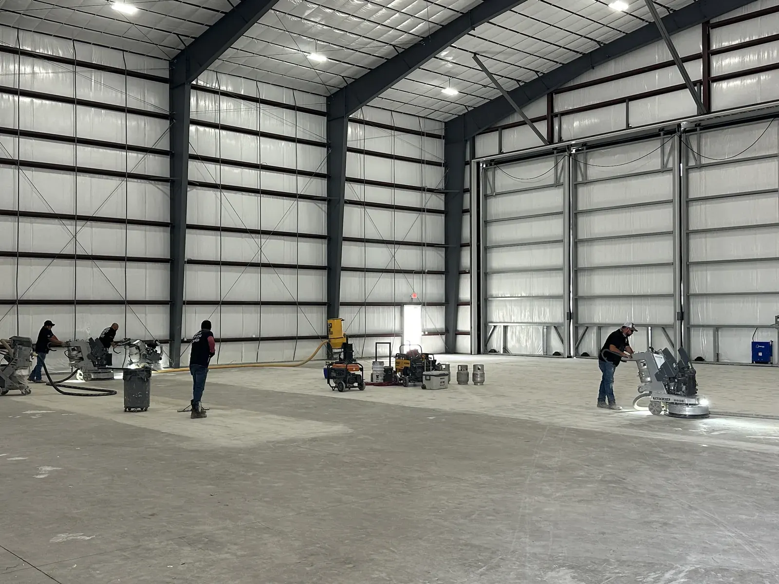 NanoTech Epoxy crew diamond grinding concrete before an epoxy installation, view 4