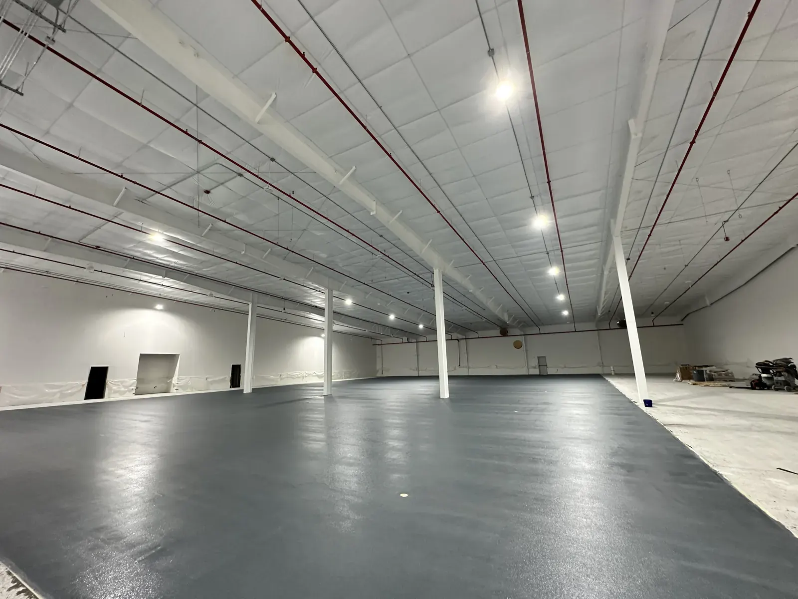Light gray solid-color epoxy floor in a studio space, view 6