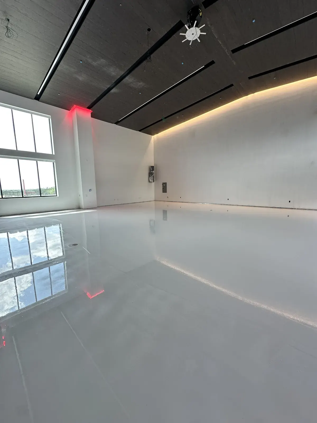 Light gray solid-color epoxy floor in a studio space, view 3