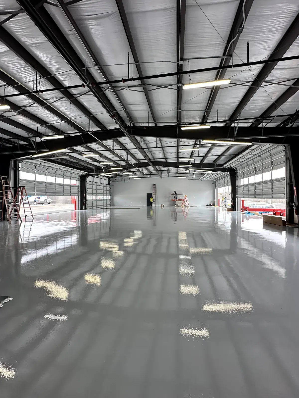 Bright white epoxy floor in a commercial shop with a high-gloss finish, view 10