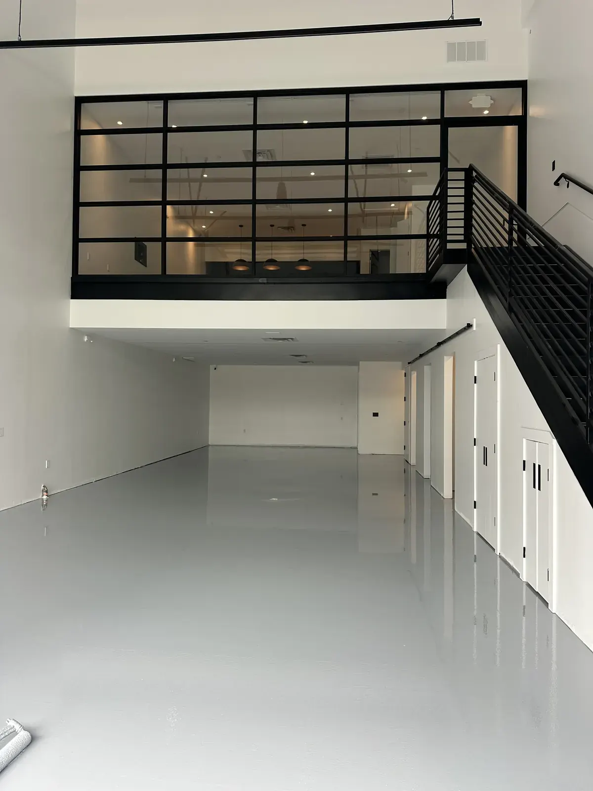 Bright white epoxy floor in a commercial shop with a high-gloss finish, view 11
