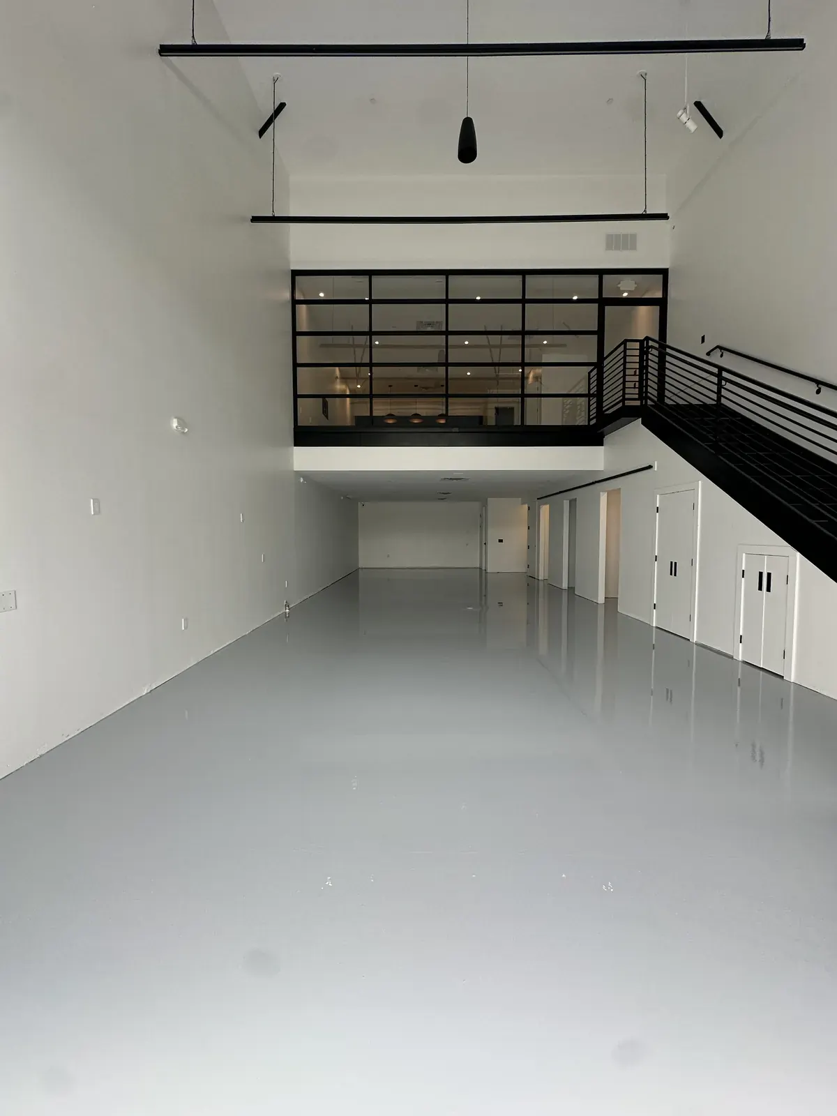 Bright white epoxy floor in a commercial shop with a high-gloss finish, view 12