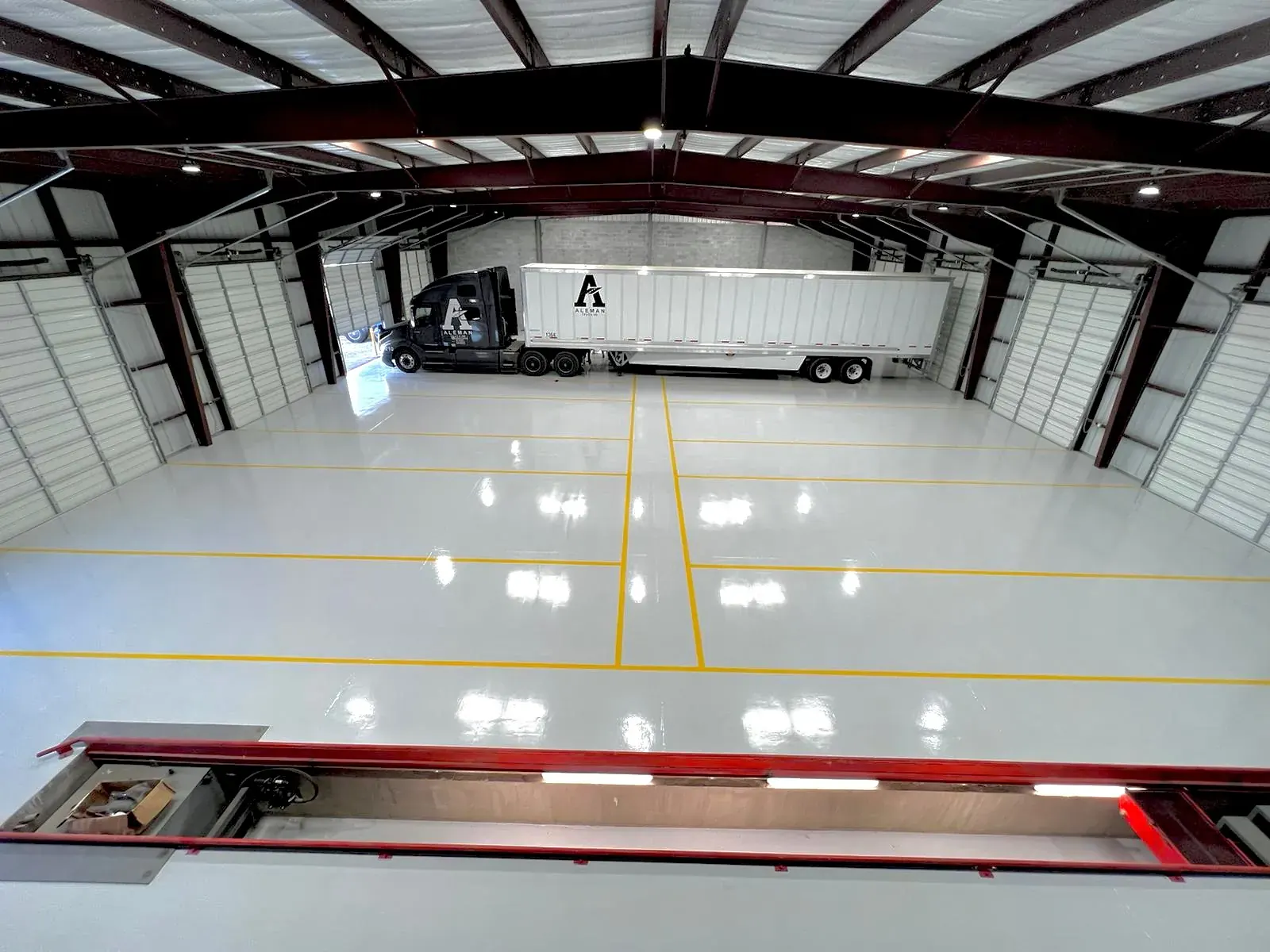 Bright white epoxy floor in a commercial shop with a high-gloss finish, view 14