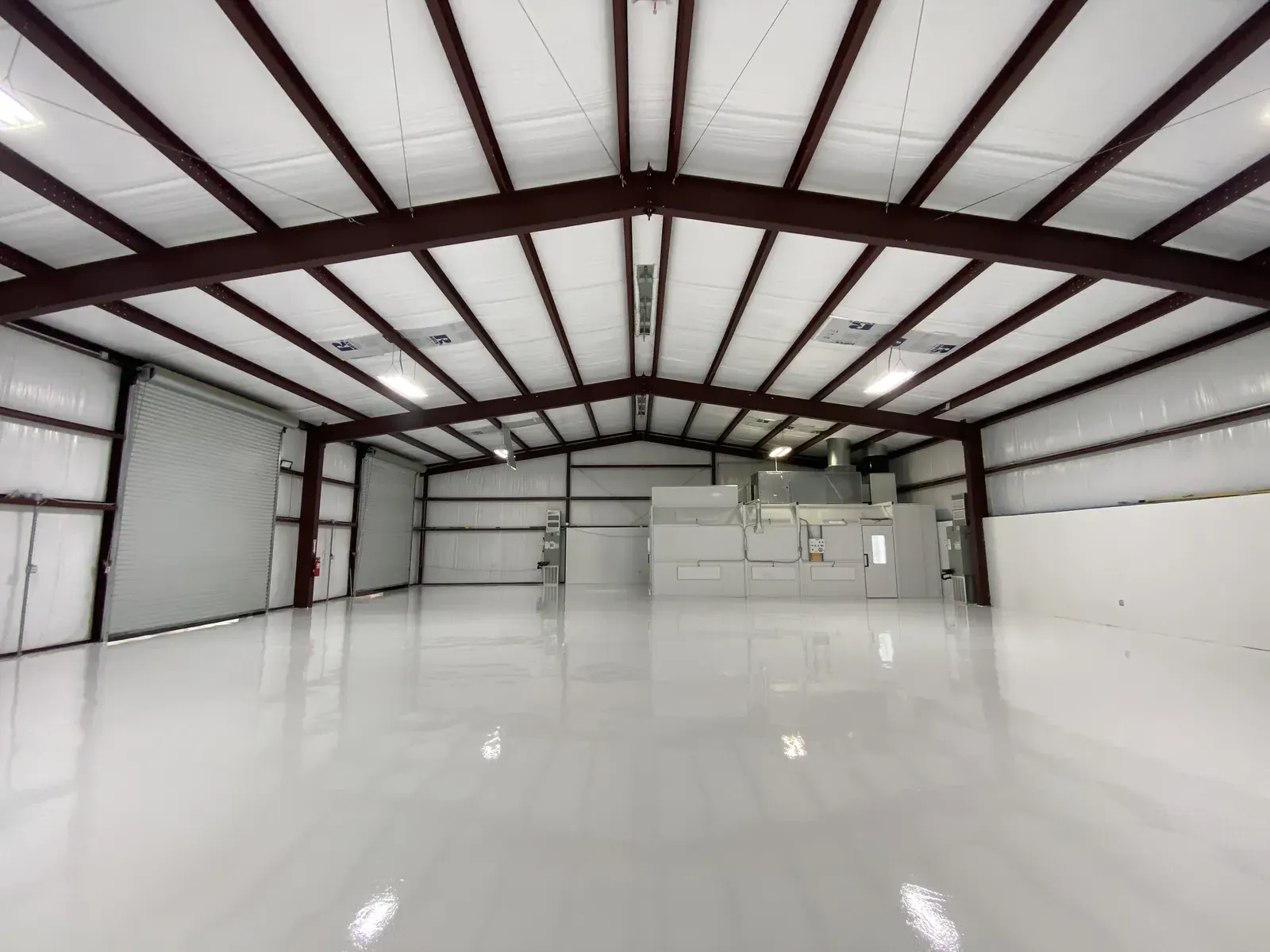 Bright white epoxy floor in a commercial shop with a high-gloss finish, view 5