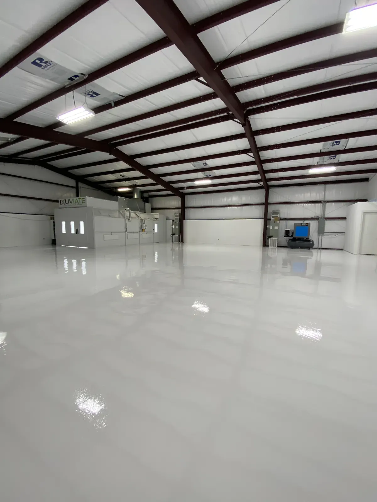 Bright white epoxy floor in a commercial shop with a high-gloss finish, view 7